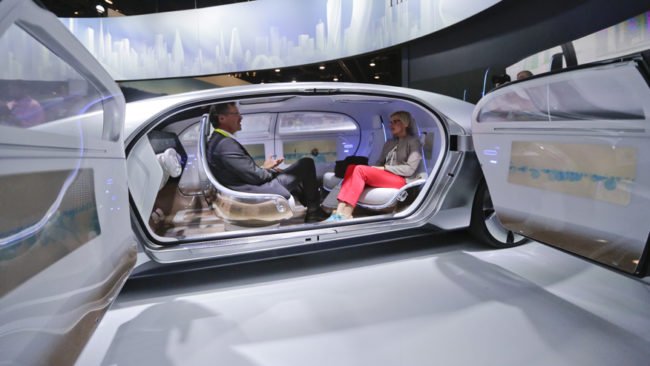 FILE - In this January 2015 file photo, attendees sit in the self-driving Mercedes-Benz F 015 concept car at the Mercedes-Benz booth at the International CES, in Las Vegas. Everything we buy or use these days has the potential to be smarter. Self-driving cars can transform our commuting hours into productive time. Sensor-laden socks can let us know how to jog with fewer injuries. The 2016 International CES will have a panoply of vendors showing off such connected devices, from smart umbrellas that will notify you if youve left them behind, to navigation devices that project directions on car windshields so you dont have to take your eyes off the road. (AP Photo/Jae C. Hong, File)