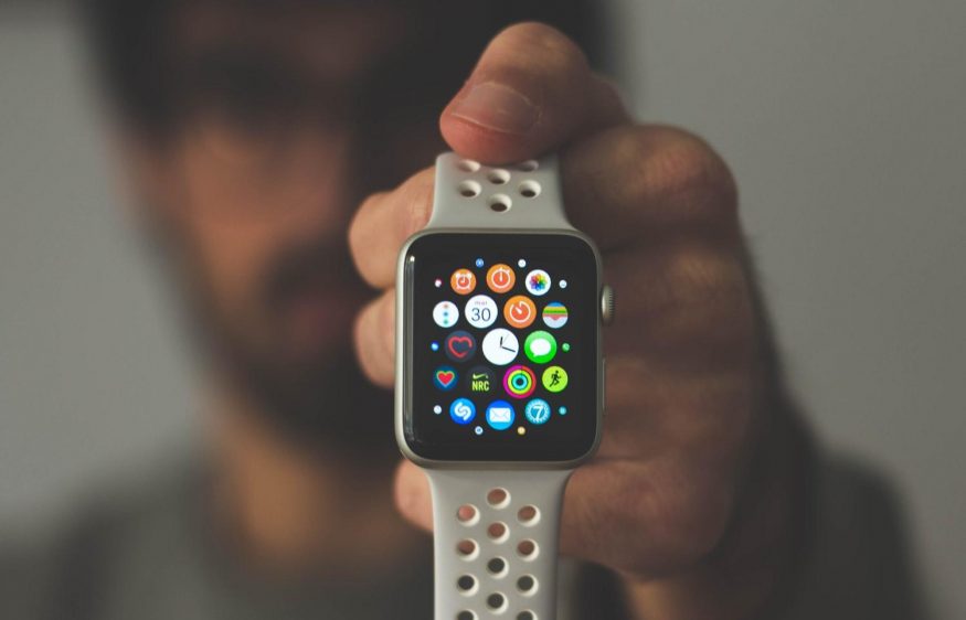 person holding silver aluminum case Apple Watch