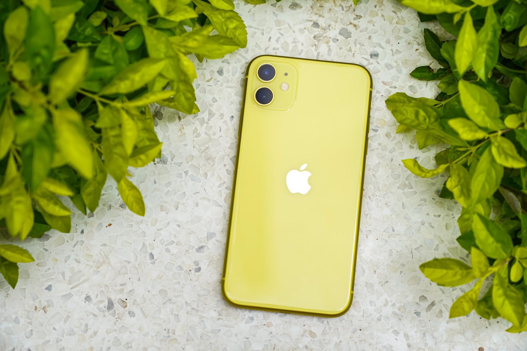 yellow iphone case on white textile