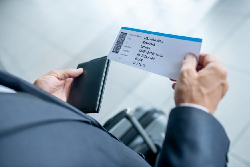 male hands holding passport and plane PR spiritmedia