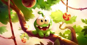 Zelená příšerka ze hry Cut the Rope sedí na stromě
