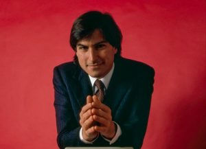 Steve Jobs v obleku při uvedení počítače Macintosh v roce 1984