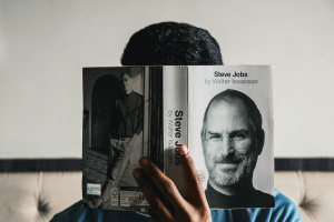 Muž si čte životopis Steva Jobse