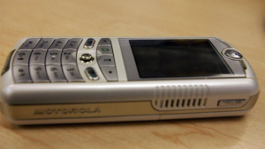 Motorola ROKR E1 s podporou iTunes Stříbrný hudební telefon Motorola ROKR E1 položený na stole
