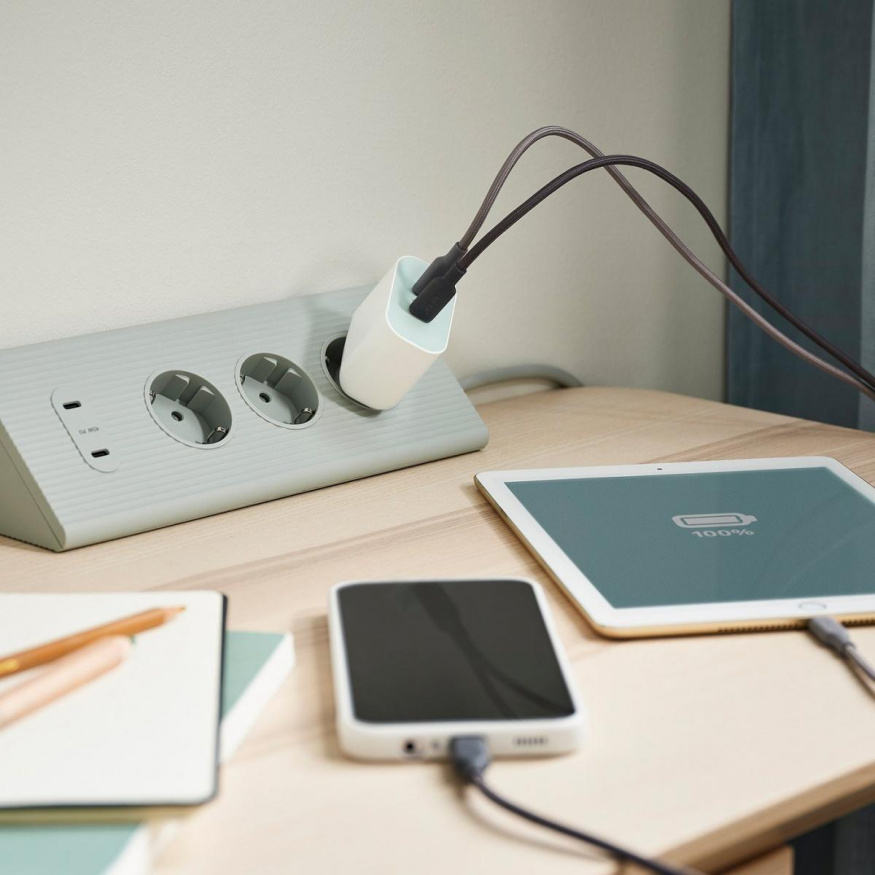 Dvouportová nabíječka IKEA SJÖSS Dvouportová nabíječka IKEA SJÖSS připojená k telefonu a tabletu na stole